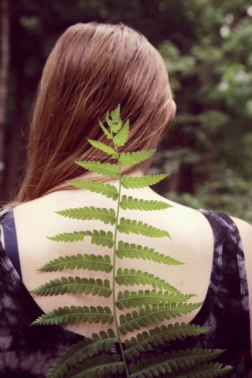 woman in black top having back pain