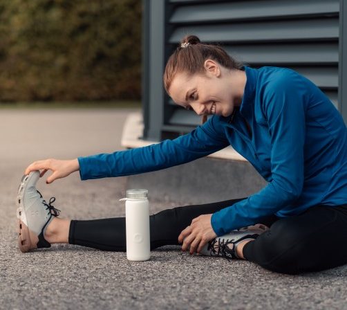 woman stretching in a custom back pain rehab program