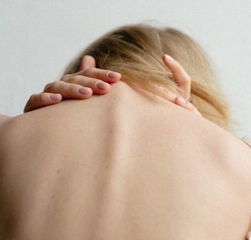 woman suffering from neck pain
